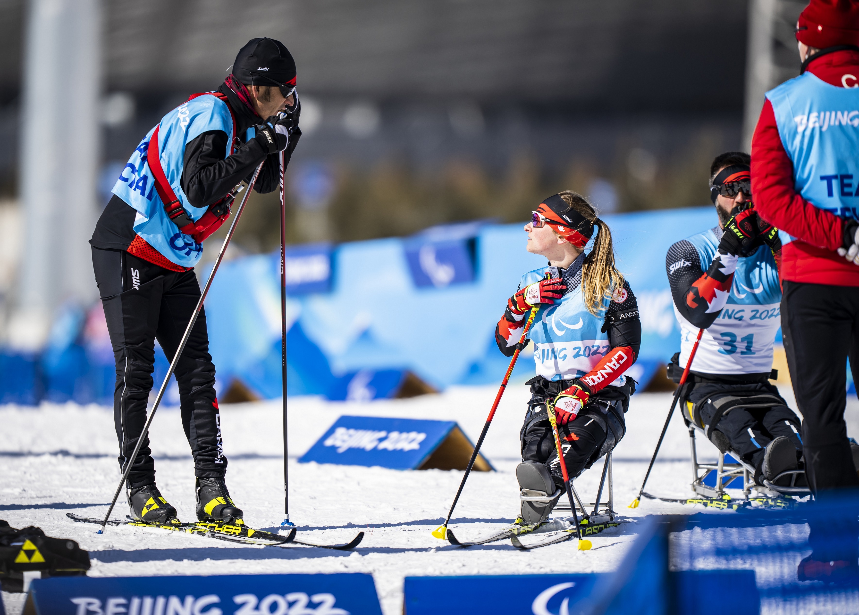 Coach Robin McKeever chats with Para nordic skier Christina Picton during training at the Beijing 2022 Paralympic Winter Games