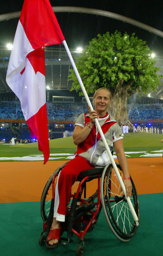 Chantale Benoit holding a Canadian flag