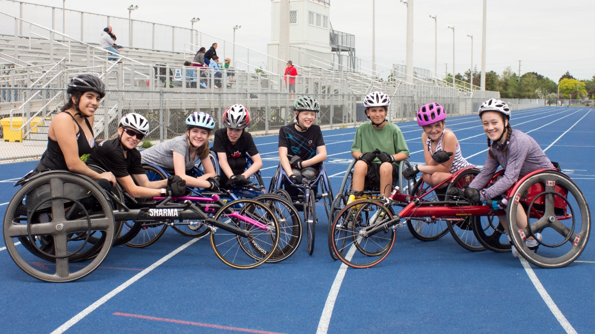 A group of Cruisers wheelchair racers together on the track