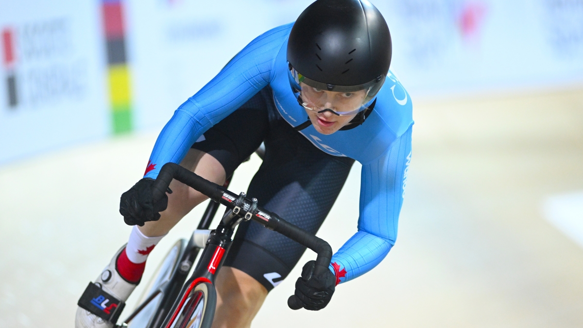 A face-on shot of Mel Pemble racing at the velodrome in France for the 2022 Para Cycling Track World Championships