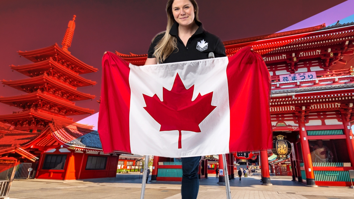 Stephanie Dixon holding the Canadian flag in front of a Tokyo backdrop