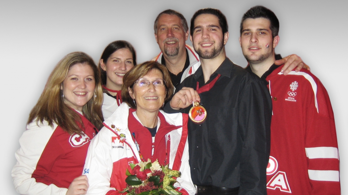 The Westlake family celebrating Canada’s gold medal win at the Torino 2006 Paralympic Winter Games, Greg’s first Paralympic Games. From left: Rachelle Westlake, Nicole Westlake, Deb Westlake, Jim Westlake, Greg Westlake, and Scott Westlake.  