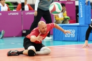 Mikael Bartholdy reaches for the ball in a game of sitting volleyball