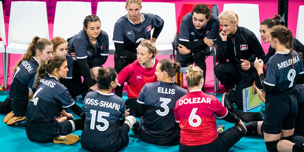 Canada's women's sitting volleyball team in a huddle at Lima 2019