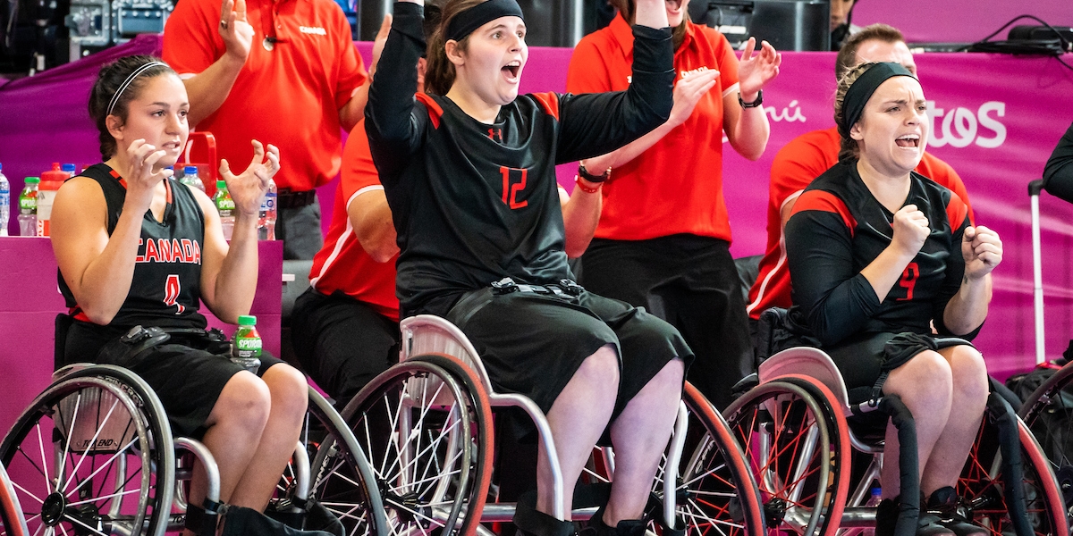 Sandrine in action playing wheelchair basketball