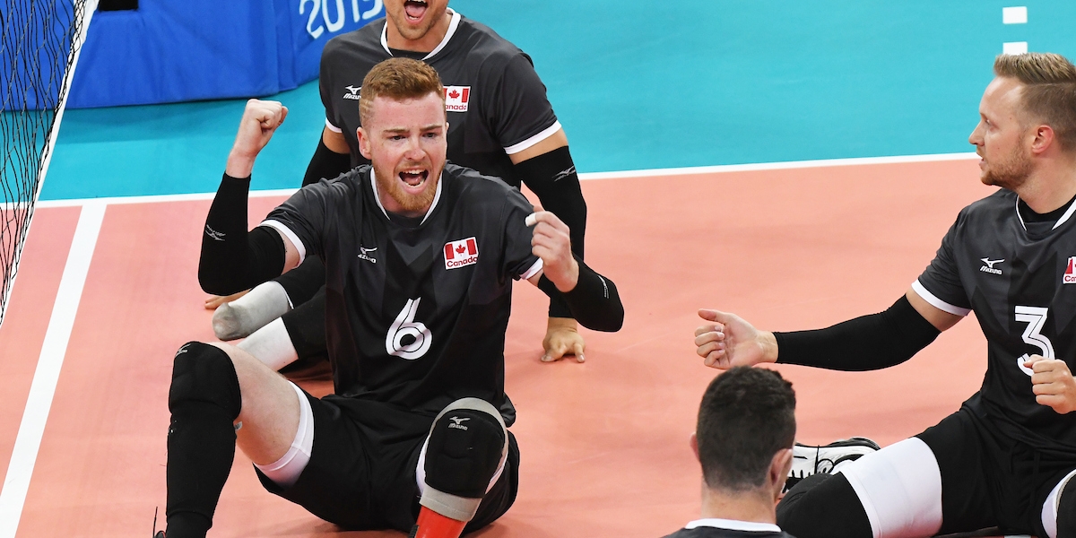 Bryce Foster celebrate a point in a game of sitting volleyball