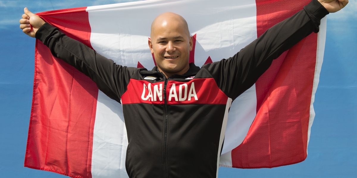 David Eng holding the Canadian flag