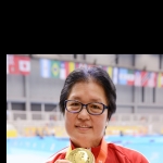 Stephanie wearing a gold medal