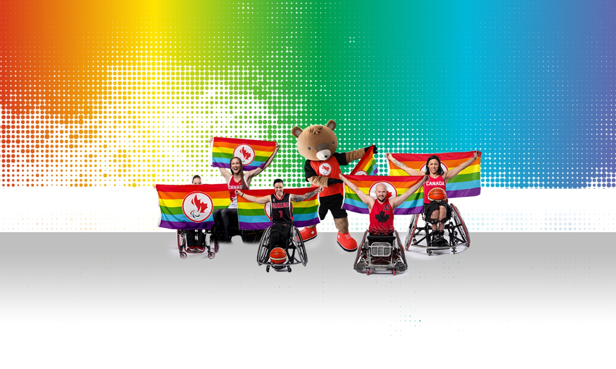 Athletes and Coda the beaver mascot with pride flags