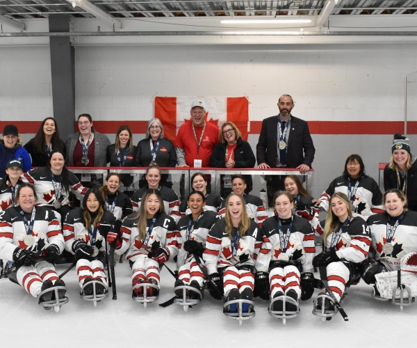 Canada's women's Para ice hockey team smiling with their silver medals at the World Challenge