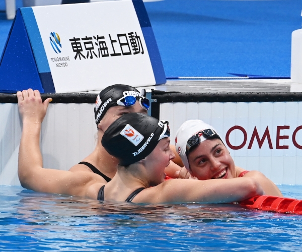 Aurelie celebrates in the pool after winning gold