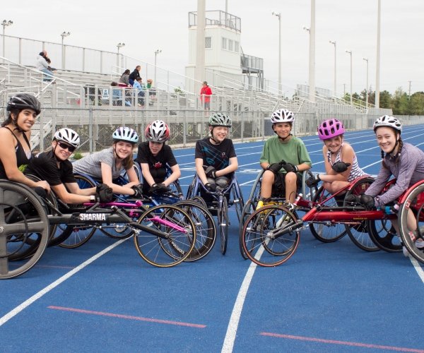 A group of Cruisers wheelchair racers together on the track
