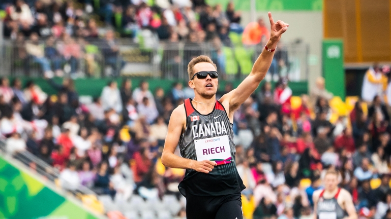 Nate Riech celebrates after winning the gold medal in men's 1500m