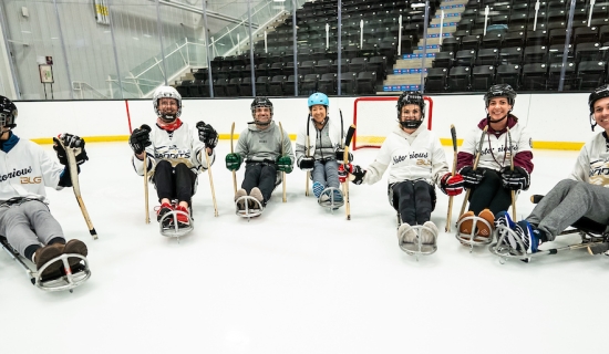 ParaTough Cup attendees in sledges playing Para ice hockey
