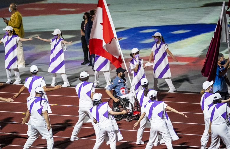 Brent Lakatos carrying the flag for Canada at the Tokyo 2020 Paralympic Games Closing Ceremony