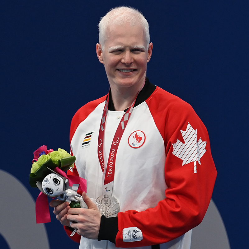 Canadian Para swimmer Nicolas-Guy Turbide celebrates with his silver medal on the podium at the Tokyo 2020 Paralympics.