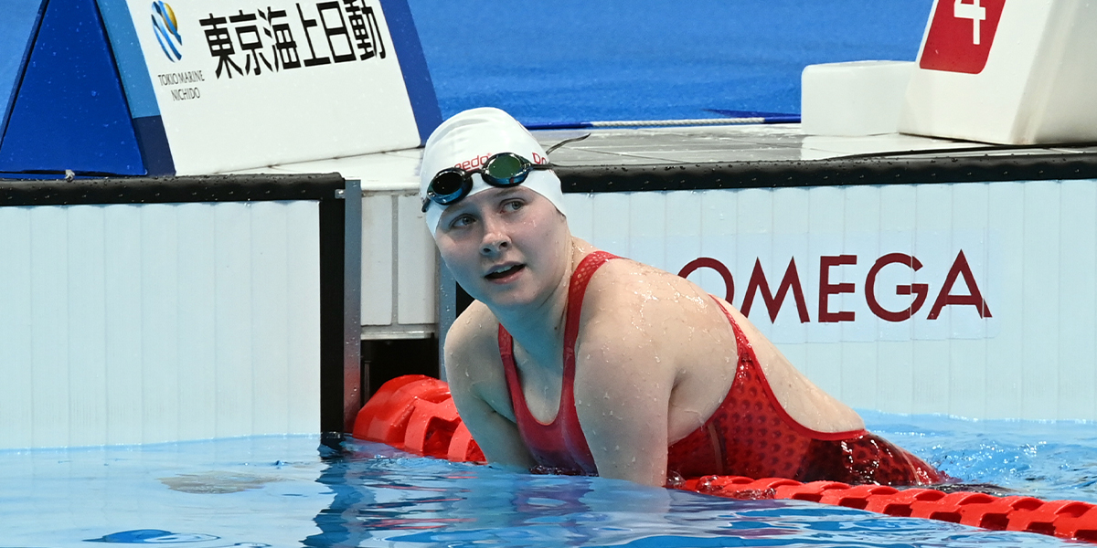 Canadian Para swimmer Danielle Dorris rests on the lane rope in the pool following her gold medal winning race at the Tokyo 2020 Paralympics.