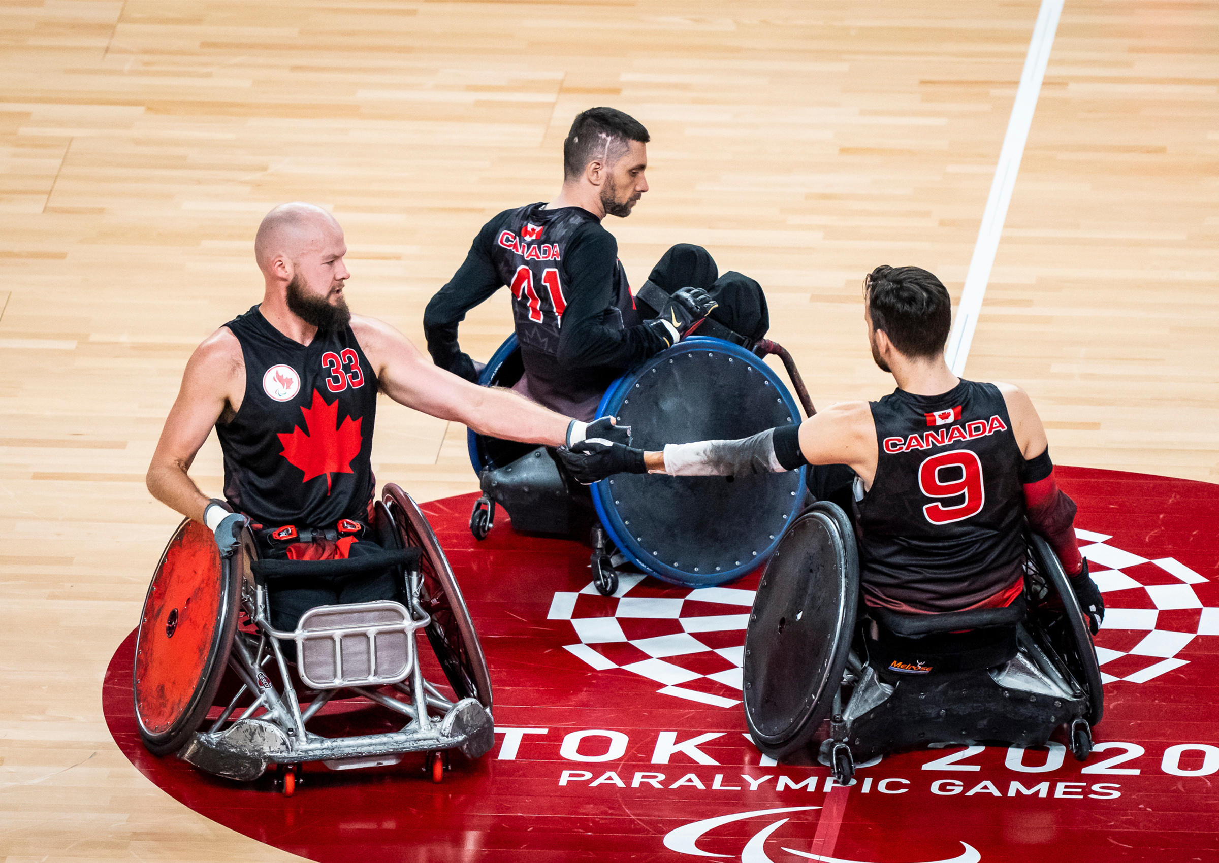 Canadian Wheelchair Rugby players congratulate each other at the Tokyo 2020 Paralympics.