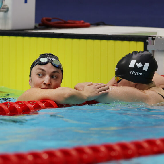 Tess Routliffe, Para swimmer, in the swimming pool with teammate Tripp.