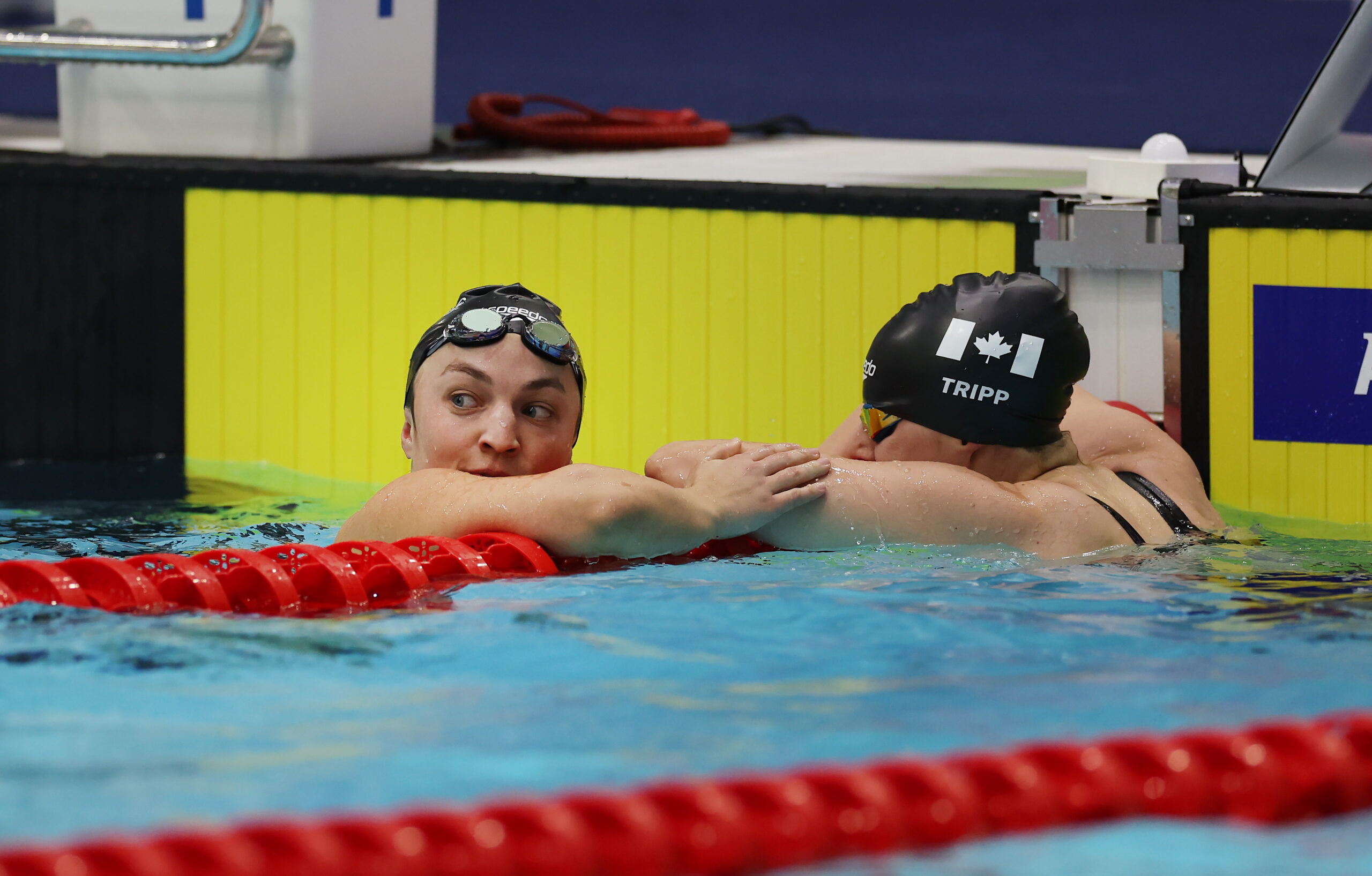 Tess Routliffe, Para swimmer, in the swimming pool with teammate Tripp.