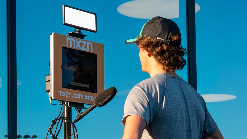 An athlete does an interview using MXZN Mixed Zone stations