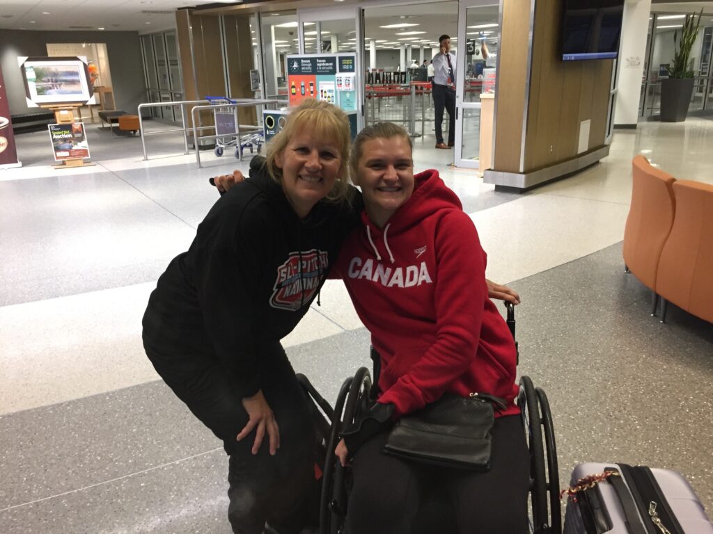 Monica (Nikita's mom) and Para swimmer Nikita Ens together at the airport.
