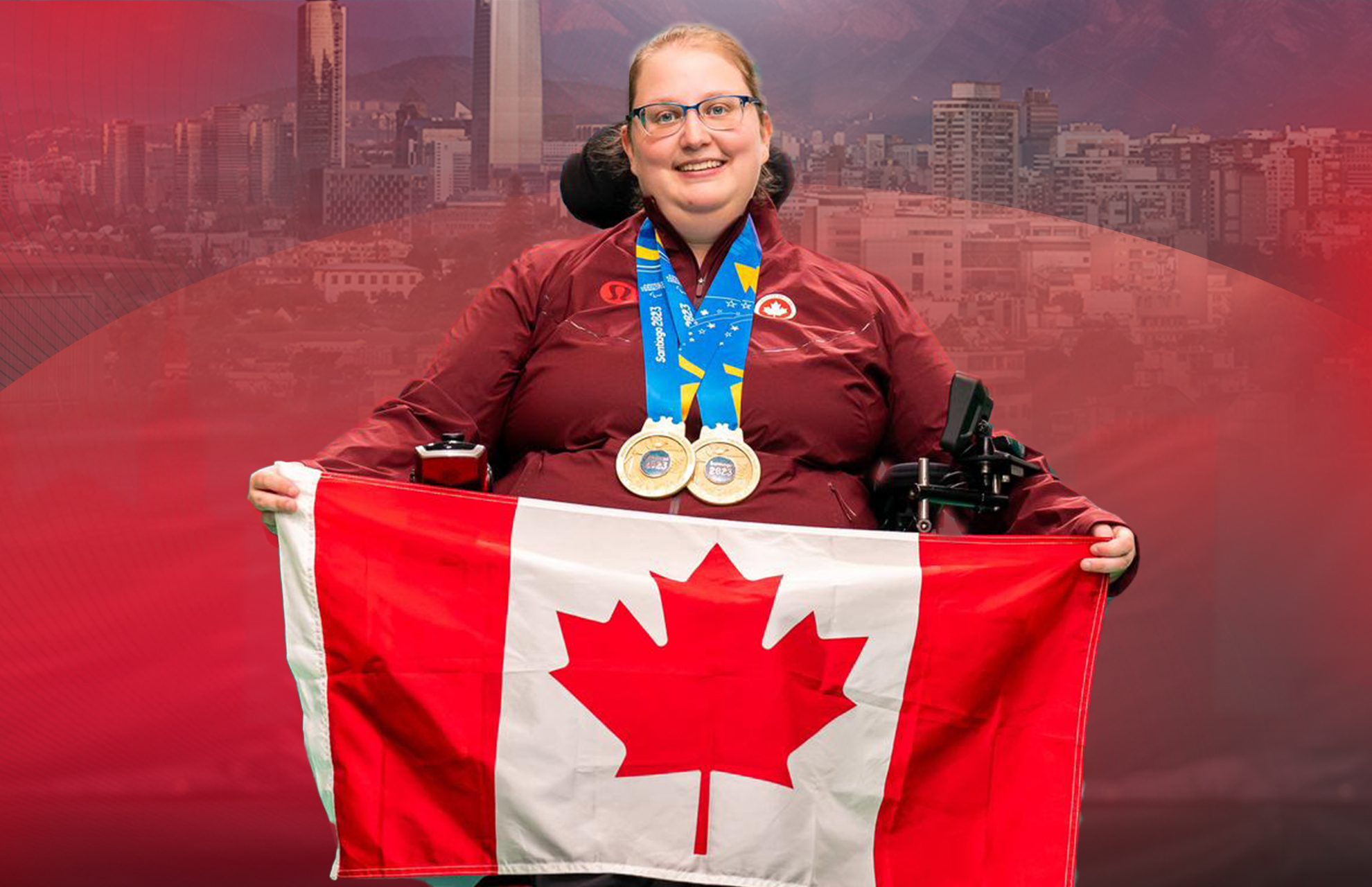 Alison Levine wearing her gold medals, smiling, holding the Canadian flag