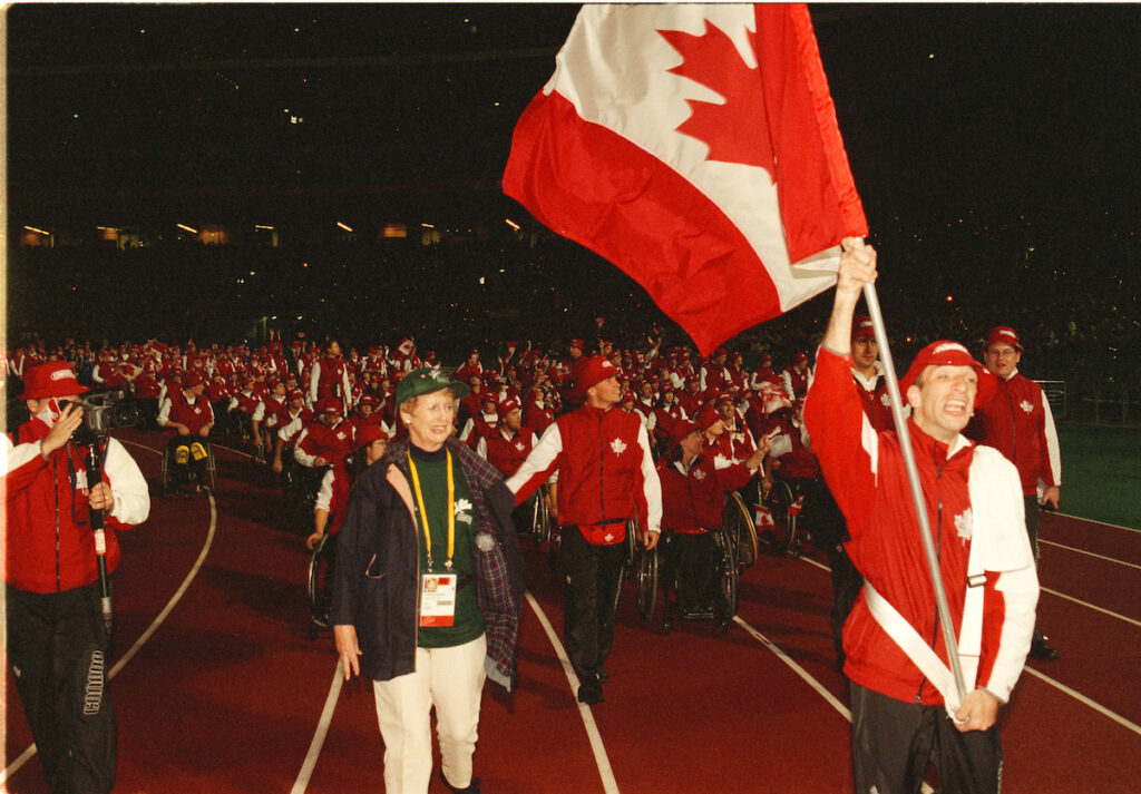 Para cyclist Gary Longhi leads Canada into the Opening Ceremony at the Sydney 2000 Paralympic Games
