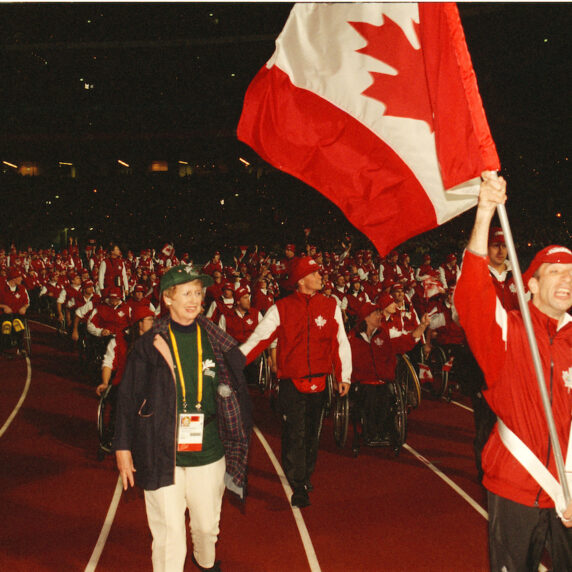 Para cyclist Gary Longhi leads Canada into the Opening Ceremony at the Sydney 2000 Paralympic Games