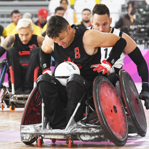 Mike Whitehead with the ball in wheelchair rugby action at the Lima 2019 Parapan Am Games.