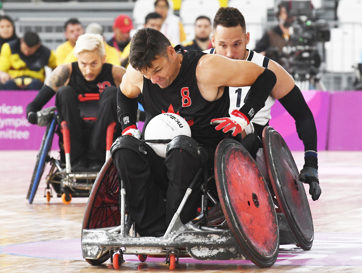 Mike Whitehead with the ball in wheelchair rugby action at the Lima 2019 Parapan Am Games.