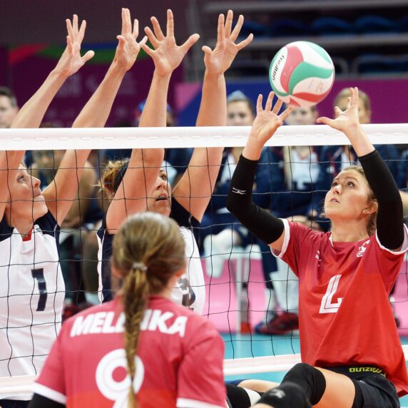 Jennifer Oakes of the Canadian women's sitting volleyball team volleys the ball.