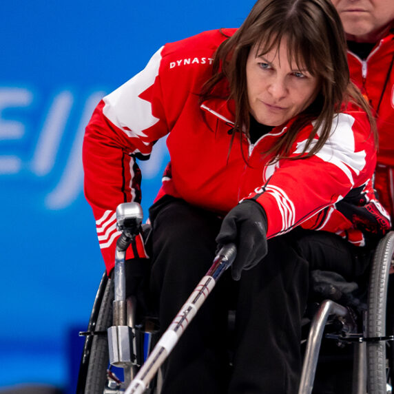 Canadian Wheelchair curling athlete Ina Forrest taking a shot during a game at the Beijing 2022 Winter Paralympics.