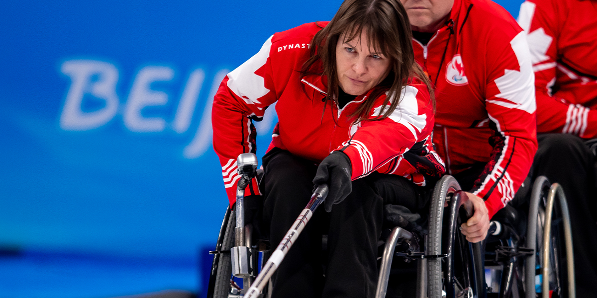 Canadian Wheelchair curling athlete Ina Forrest taking a shot during a game at the Beijing 2022 Winter Paralympics.