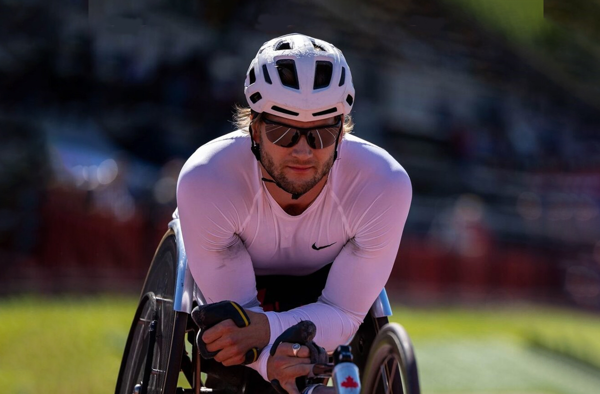 Canadian wheelchair racer Austin Smeenk resting on his racing wheelchair following a race at the 2024 Athletics Canada Paralympics Trials.