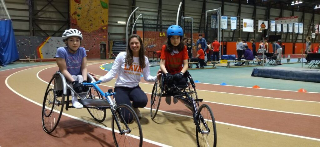 Camille Rheault and two kids posing on the indoor track