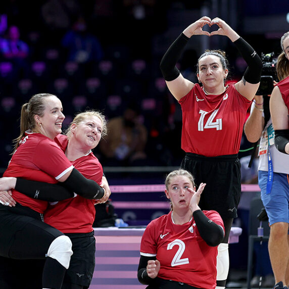 Team Canada Women's sitting volleyball team celebrate after victory against Slovenia