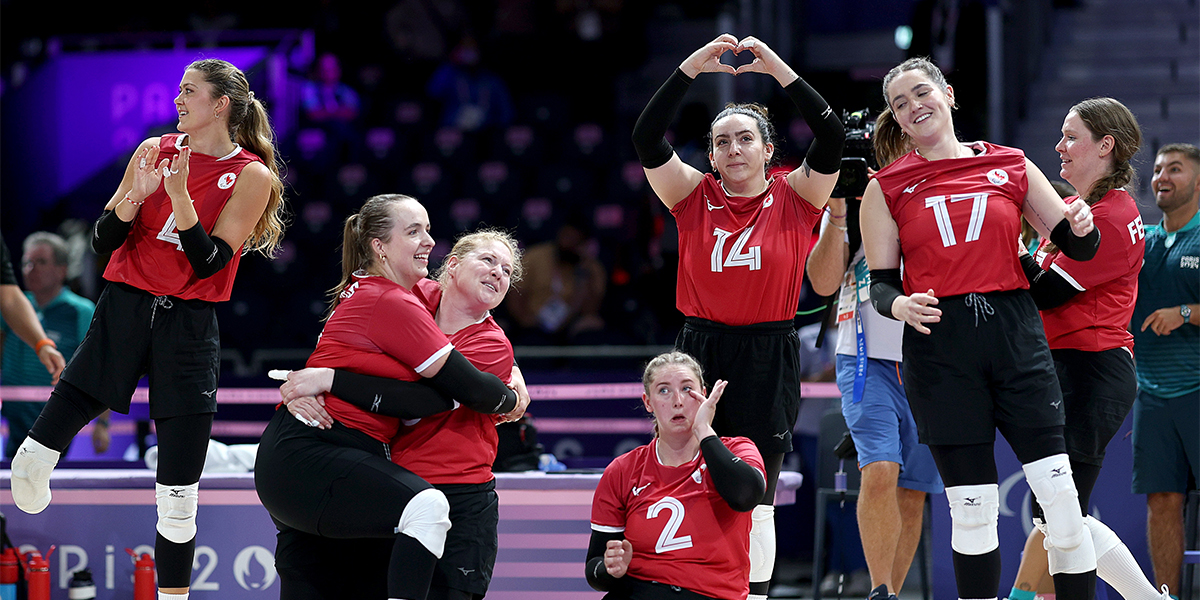 Team Canada Women's sitting volleyball team celebrate after victory against Slovenia