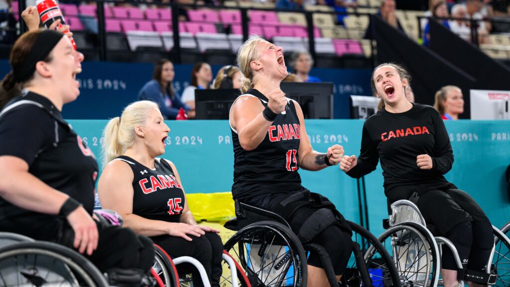 Canadian wheelchair basketball players celebrate on the bench