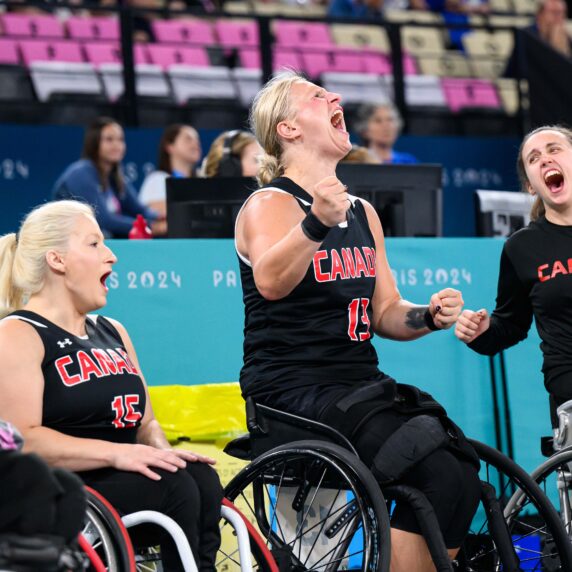 Canadian wheelchair basketball players celebrate on the bench