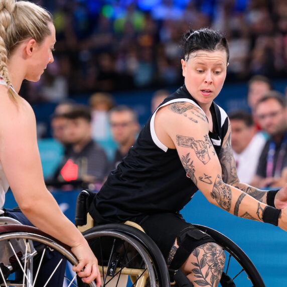 Cindy Ouellet holds the ball in a match of wheelchair basketball