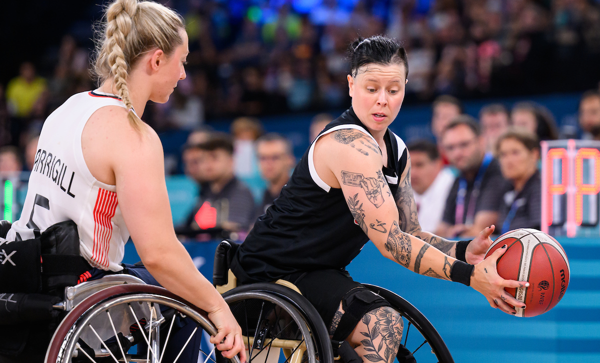 Cindy Ouellet holds the ball in a match of wheelchair basketball