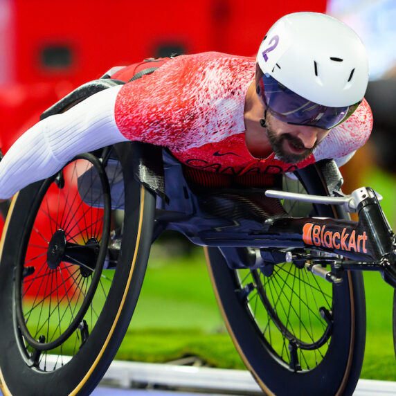 Brent Lakatos with his head forward racing in Paris.