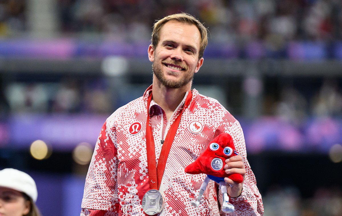 Nate Riech smiling after receiving his silver medal