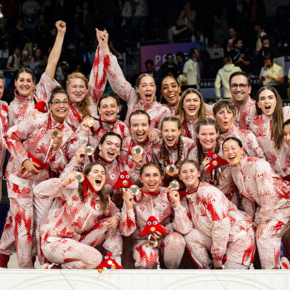 The Canadian Paralympic sitting volleyball team celebrates with their gold medals.