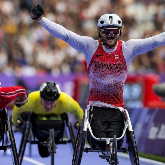 Austin Smeenk celebrates his gold medal race after crossing the finish line