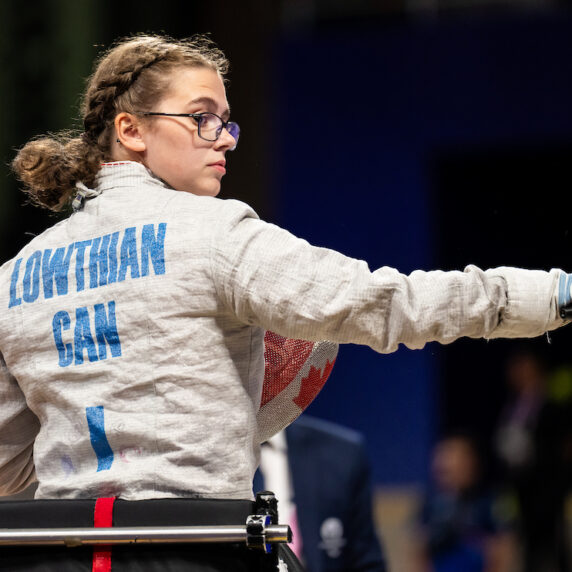 Trinity Lowthian holds her sabre pointing it to the right