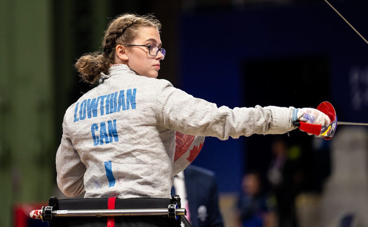 Trinity Lowthian holds her sabre pointing it to the right