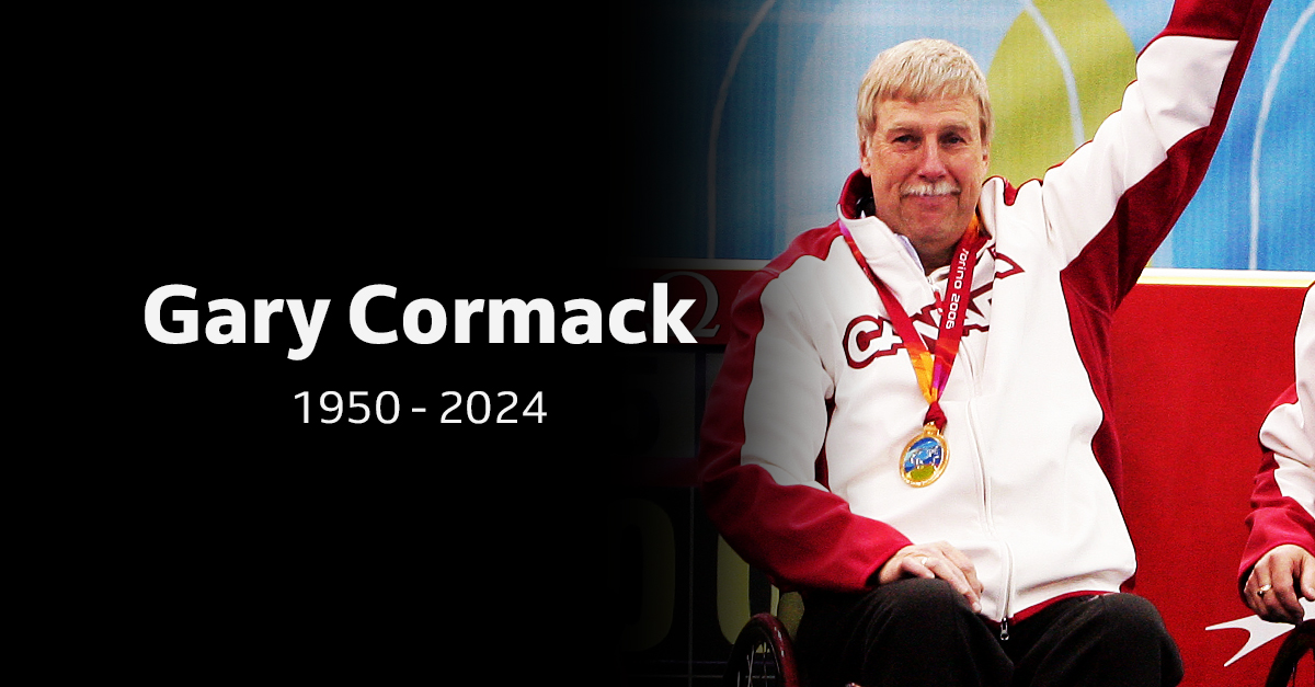 Portrait of Canadian Paralympian Gary Cormack, 1950-2024, wearing a Team Canada jacket and medal, raising his arm in celebration.