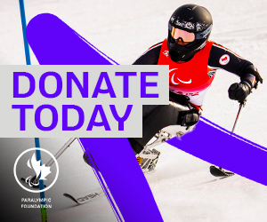 Katie Combaluzier, a Canadian Para alpine skier, navigates the slopes in a sit-ski, wearing a black helmet and red Paralympic bib. A dynamic purple design overlays the image, featuring the Paralympic Foundation of Canada logo and the phrase ‘DONATE TODAY’ in bold text.